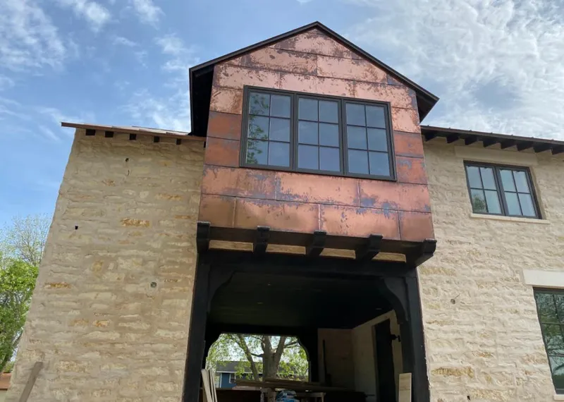 Copper metal panel facade on a stone building for Skylight Installation in Westchase