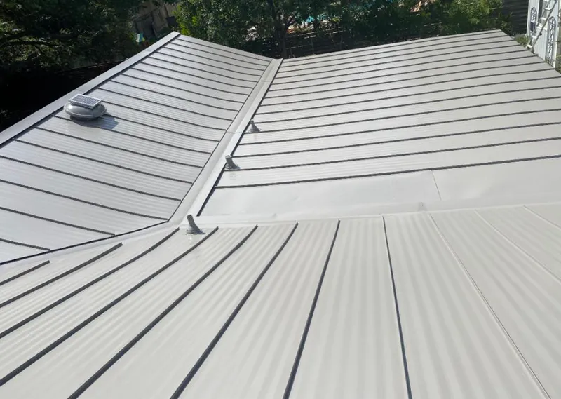 Solar attic fan installed on a metal roof for Roof Ventilation in Westchase